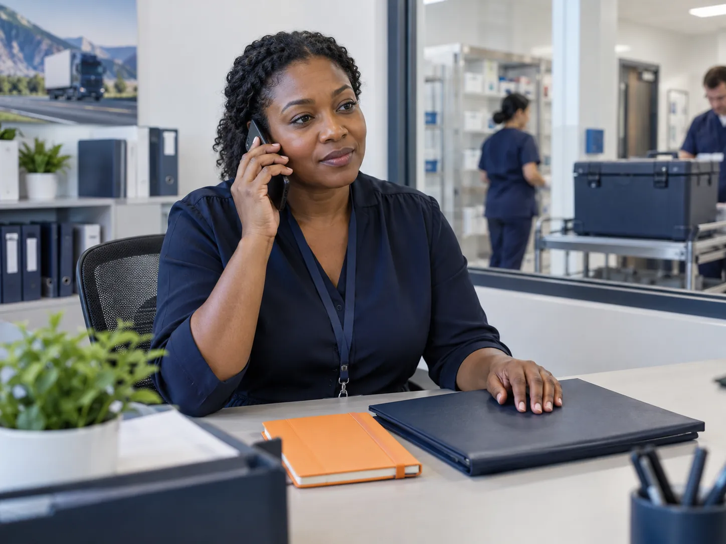 Medical logistics coordinator taking a phone call to clarify the next step for a delivery exception
