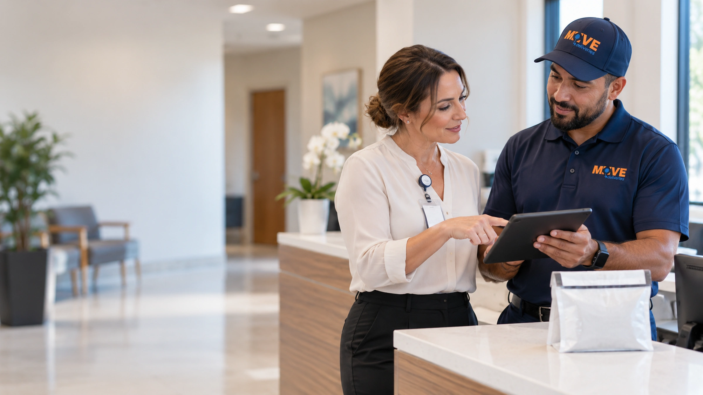 Practice manager and delivery coordinator reviewing delivery information on a tablet