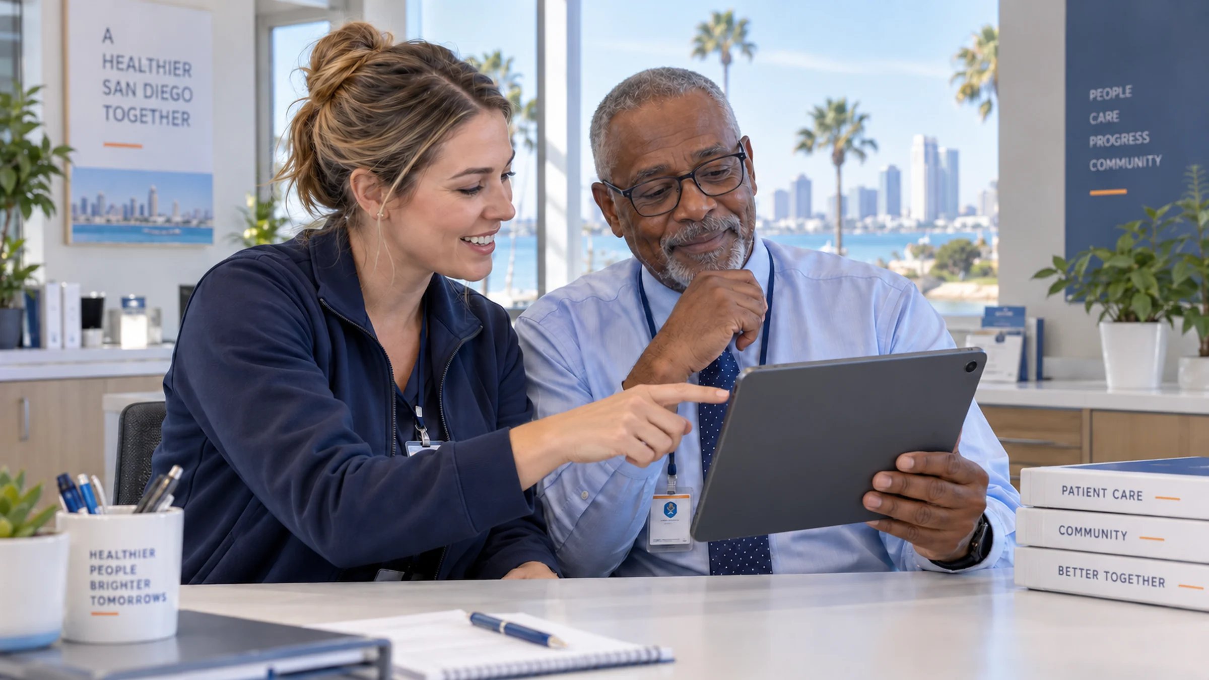 Illustrative San Diego coordinator and clinic colleague reviewing completion updates